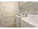 This laundry room features a washer, dryer and overhead storage, perfect for organization at 2928 Moss Bridge Ln., Myrtle Beach, SC 29579