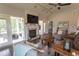 Spacious living room with a fireplace, open floor plan, and sliding doors to the backyard at 2928 Moss Bridge Ln., Myrtle Beach, SC 29579