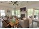 Comfortable living room featuring a fireplace, ceiling fan, and access to the outdoors at 2928 Moss Bridge Ln., Myrtle Beach, SC 29579