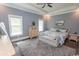 Spacious main bedroom with a tray ceiling, soft gray walls, and lots of natural light at 2928 Moss Bridge Ln., Myrtle Beach, SC 29579