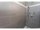 This shower features gray tiling, a mosaic accent strip, and a shower head at 2928 Moss Bridge Ln., Myrtle Beach, SC 29579