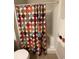 Bright bathroom with a colorful, patterned shower curtain and neutral tile at 307 Black Oak Ln. # 102, Murrells Inlet, SC 29576