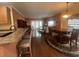 An open-concept living room with dining area featuring hardwood floors and plenty of natural light at 307 Black Oak Ln. # 102, Murrells Inlet, SC 29576