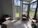 Bright and airy sunroom with comfortable seating and views of the backyard at 307 Black Oak Ln. # 102, Murrells Inlet, SC 29576