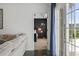 Bedroom view with a ceiling fan, door to backyard, and adjoining bathroom at 313 Palladium Dr., Surfside Beach, SC 29575