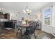 View of dining area and adjacent kitchen with wooden table and black chairs at 313 Palladium Dr., Surfside Beach, SC 29575