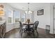 Cozy dining area with a black table and chairs, chandelier, and bright natural light at 313 Palladium Dr., Surfside Beach, SC 29575