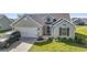 Charming single-story home featuring a well-manicured lawn and attached two-car garage at 313 Palladium Dr., Surfside Beach, SC 29575