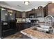 Kitchen with dark cabinets, black appliances, countertops, and tile backsplash at 313 Palladium Dr., Surfside Beach, SC 29575