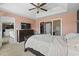 Comfortable main bedroom with tray ceilings, fan, and access to the closet at 313 Palladium Dr., Surfside Beach, SC 29575