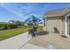 Backyard patio with outdoor dining set, an umbrella, and well-maintained landscaping at 313 Palladium Dr., Surfside Beach, SC 29575