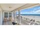 Charming covered balcony with seating, offering panoramic ocean views and easy beach access at 324 S Waccamaw Dr., Garden City Beach, SC 29576