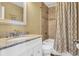 Bathroom featuring a granite countertop vanity and a tiled shower and tub combo with shower curtain at 324 S Waccamaw Dr., Garden City Beach, SC 29576