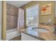 Spacious bathroom boasting a granite countertop vanity, tub/shower, and beachy decor at 324 S Waccamaw Dr., Garden City Beach, SC 29576