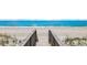 Wooden boardwalk provides direct beach access with ocean view and lush dune vegetation on both sides at 324 S Waccamaw Dr., Garden City Beach, SC 29576