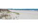 Expansive beach view, showcasing golden sand meeting the ocean under a bright sky at 324 S Waccamaw Dr., Garden City Beach, SC 29576