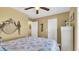 Cozy bedroom with neutral walls, ceiling fan, and ocean-themed decor at 324 S Waccamaw Dr., Garden City Beach, SC 29576
