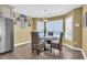 Dining area with seating for four, a modern chandelier, and large windows overlooking the beach at 324 S Waccamaw Dr., Garden City Beach, SC 29576