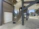 Ground level space featuring sturdy support columns, stairs, and a glimpse of nearby surroundings at 324 S Waccamaw Dr., Garden City Beach, SC 29576