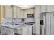 Modern kitchen features granite countertops, stainless steel appliances, and bright lighting at 324 S Waccamaw Dr., Garden City Beach, SC 29576