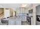 Stylish kitchen with granite counters, stainless appliances, and a functional island layout at 324 S Waccamaw Dr., Garden City Beach, SC 29576