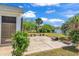 Back patio features seating, a tranquil lake view, and lush landscaping at 3315 Saddlewood Circle, Myrtle Beach, SC 29579