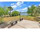 Landscaped backyard featuring a patio, decorative benches, and a scenic lake view at 3315 Saddlewood Circle, Myrtle Beach, SC 29579