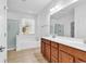 Modern bathroom features a double vanity, large mirror, and a separate shower and tub at 3315 Saddlewood Circle, Myrtle Beach, SC 29579