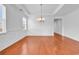 Dining room featuring hardwood floors, tray ceilings, and decorative chandelier at 3315 Saddlewood Circle, Myrtle Beach, SC 29579