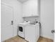 Well-lit laundry room with washer, dryer, and ample storage cabinets at 3315 Saddlewood Circle, Myrtle Beach, SC 29579