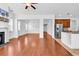 Bright, open-concept living room with hardwood floors, white trim, and stainless steel appliances at 3315 Saddlewood Circle, Myrtle Beach, SC 29579