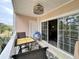 Balcony with seating area, ceiling fan and a sliding glass door to the interior at 3979 Forsythia Ct. # 203, Myrtle Beach, SC 29588