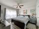 Light-filled bedroom featuring a king-sized bed, ceiling fan, and coastal decor at 3979 Forsythia Ct. # 203, Myrtle Beach, SC 29588