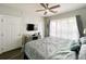 Comfortable bedroom featuring a king-sized bed, ceiling fan, and ample natural light at 3979 Forsythia Ct. # 203, Myrtle Beach, SC 29588