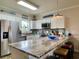 Stylish kitchen featuring white cabinets, stainless steel appliances, and a luxurious countertop at 3979 Forsythia Ct. # 203, Myrtle Beach, SC 29588