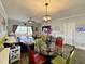 Open concept living area featuring a glass dining table and access to the outdoor balcony at 3979 Forsythia Ct. # 203, Myrtle Beach, SC 29588