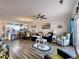 Bright living room flows into the kitchen area, featuring luxury vinyl flooring and coastal decor at 3979 Forsythia Ct. # 203, Myrtle Beach, SC 29588
