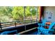 Comfortable screened patio features bright blue Adirondack chairs and peaceful views, perfect for relaxing outdoors at 415 Ocean Creek Dr. # 2216, Myrtle Beach, SC 29572