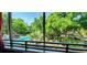 Scenic view from the screened porch overlooking the lush landscaping and refreshing pool, perfect for enjoying the outdoors at 415 Ocean Creek Dr. # 2216, Myrtle Beach, SC 29572
