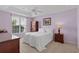 Cozy bedroom with a tray ceiling, a large window, and traditional wooden furniture at 432 Warrington Way # 432, Murrells Inlet, SC 29576