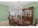 Formal dining room featuring an elegant chandelier, wooden table, and a large china cabinet with decorative dishware at 432 Warrington Way # 432, Murrells Inlet, SC 29576