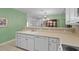 Open kitchen with a large sink, white cabinets, and a view into the dining area at 432 Warrington Way # 432, Murrells Inlet, SC 29576