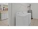 Laundry room with white washer and dryer, shelving, and a glimpse into an adjacent room at 432 Warrington Way # 432, Murrells Inlet, SC 29576