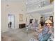 Open-concept living area with carpet, high ceilings, a loft, and a glimpse into the dining room at 432 Warrington Way # 432, Murrells Inlet, SC 29576