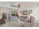 Spacious living room with a loft overlooking the area, staircase, carpeted flooring, and floral furniture at 432 Warrington Way # 432, Murrells Inlet, SC 29576