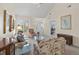 Comfortable living room with a vaulted ceiling, plush floral sofas, and a view of the front entrance at 432 Warrington Way # 432, Murrells Inlet, SC 29576
