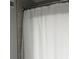 Bathroom detail featuring a white shower curtain and neutral tile at 4350 Intercoastal Dr. # 2302, Little River, SC 29566