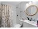 Clean, bright bathroom with subway tile in shower and gray and white floral patterned shower curtain at 4470 Little River Inn Ln. # 1005, Little River, SC 29566