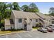 Two-story condo building exterior showcasing the facade with stairwell access and parking area at 4470 Little River Inn Ln. # 1005, Little River, SC 29566
