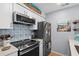 Well-equipped kitchen with stainless appliances, blue patterned backsplash, and ample storage space at 4470 Little River Inn Ln. # 1005, Little River, SC 29566